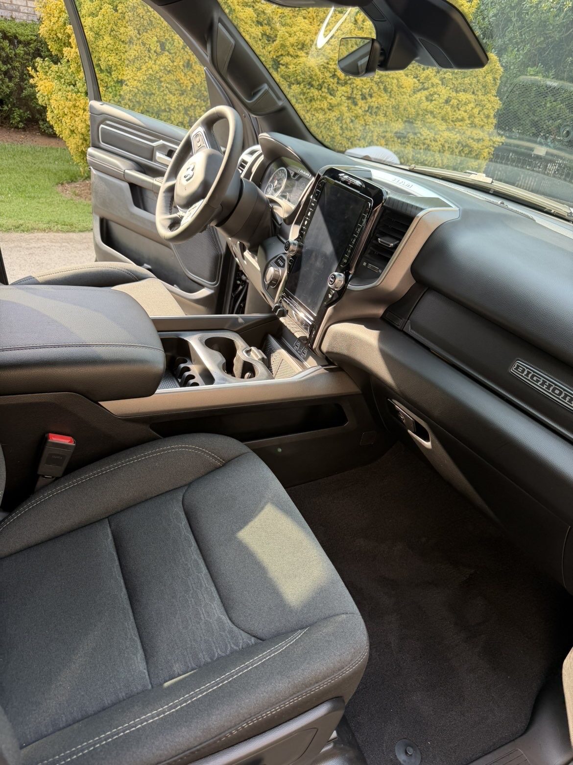 Ram 1500 Big Horn truck interior detailed with clean carpets, seats and dashboard